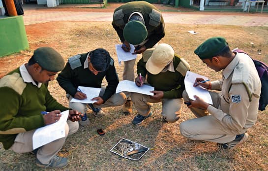 With the help of photographs of scenarios, objects indicating human presence, and animal signs they are likely to encounter during their patrols, forest guards learn to make detailed observations and record them on data-sheets.