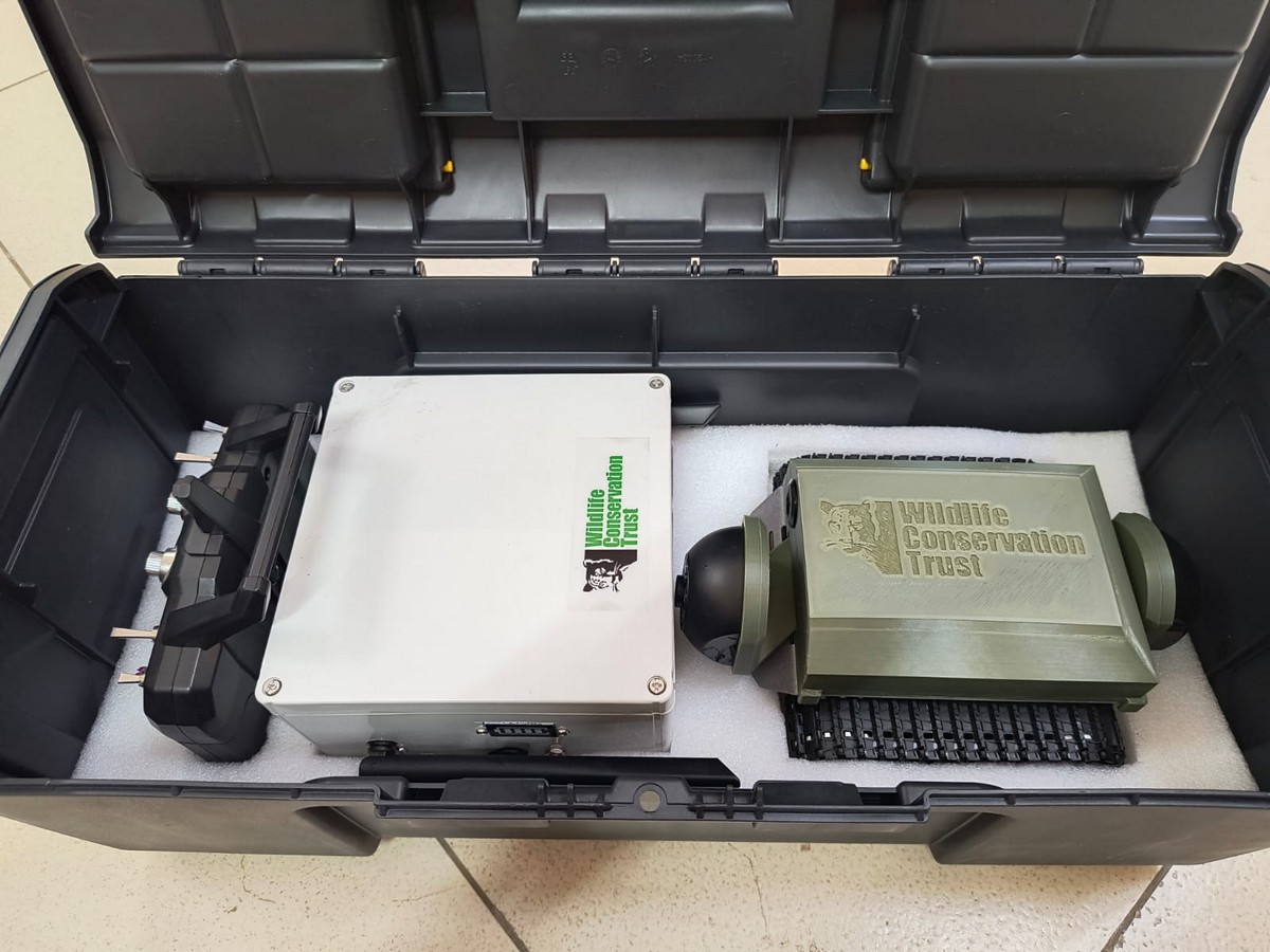 Pangolin BurrowCam, a remotely operated and telemetered vehicle with a camera that can move through rugged terrain like a miniature tank, for monitoring habitats of fossorial animals such as pangolins with image and video capabilities.